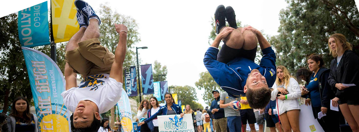 Two UC San Diego students do flips in the air