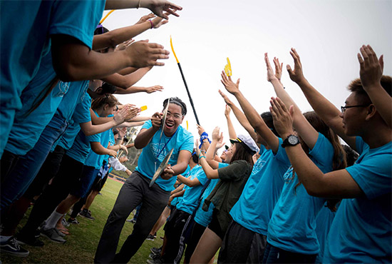 UC San Diego students participating in annual Welcome Week activities - it's a high-five gauntlet