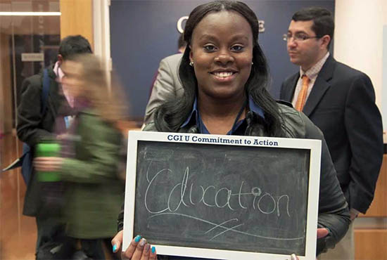 UC San Diego student at CGI U - holding up sign with her commitment to action - EDUCATION