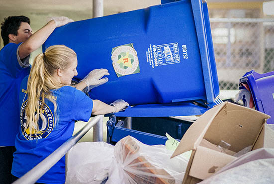 Two UC San Diego students working at a recycle / trash area for Volunteer50, UCSD's volunteer program - photo by Erik Jepsen, UC San Diego Publications